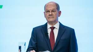 epa09600964 Acting German Minister of Finance and Social Democratic Party (SPD) top candidate for the federal elections Olaf Scholz looks on during the presentation of the coalition contract in Berlin, Germany, 24 November 2021. Members of German parties Social Democrats (SPD), Free Democrats (FDP ) and Greens were leading talks since German federal elections took place on 26 September 2021. On 24 November the participating parties are about to present the result of those talks, and the expected coalition contract.  EPA/CLEMENS BILAN