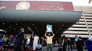 epa10106460 Supporters of Iraqi Shiite cleric Muqtada al-Sadr, head of the Sadrist movement, gather at the gate of Iraqi parliament building in the so-called 'Green Zone' in central Baghdad, Iraq, 04 August 2022. Thousends of the popular Shiite cleric Muqtada al-Sadr are still gathering inside the Iraqi parliament building in the heavily fortified Green Zone, home to government buildings and foreign embassies in Baghdad, protesting against a premiership candidate announced by the Shiite Coordination Framework, while the Iraqi Prime Minister called on supporters of the Sadrist movement to withdraw from the Iraqi parliament building.  EPA/AHMED JALIL