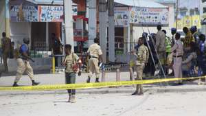 epa10130094 Somali security officials gather at the cordoned-off scene of an attack, outside the Hayat Hotel in Mogadishu, Somalia, 20 August 2022. According to Somaliaâ€™s security officials, at least 10 people were killed in the attack reportedly carried out by al-Shabab militants on 19 August. The attack involved explosions outside the hotel and gunfire.  EPA/SAID YUSUF WARSAME