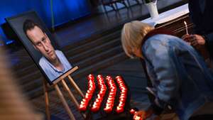 epaselect epa11388620 People attend a memorial service for late Russian opposition leader Alexei Navalny (on portrait L) honoring him on his birthday, June 4th, at the Church of Saint Mary (Marienkirche) in Berlin, Germany, 04 June 2024. Outspoken Kremlin critic Navalny died at the age of 47 in an arctic penal colony on 16 February 2024 after being transferred there in 2023. The colony is considered to be one of the world's harshest prisons.  EPA/HANNIBAL HANSCHKE