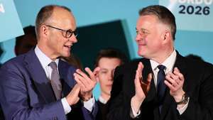 epa12836991 Christian Democratic Union (CDU) top regional candidate for the 2026 state elections in Rhineland-Palatinate Gordon Schnieder (R) and German Chancellor Friedrich Merz speak during a campaign event of the CDU party for the state election of Rhineland-Platinate in Bad Duerkheim, Germany, 20 March 2026. State elections will be held in Rhineland -Platinate on 22 March 2026.  EPA/RONALD WITTEK