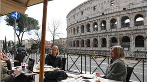 epa08979802 Customers seated at tables outside a cafe eat lunch front a Coliseum in Rome, Italy, 01 February 2021. As many as 293,000 bars, restaurants, pizzerias and agritourism that survived the closures in the regions now classified in the yellow zone were reopened for table or counter service. Regions have entered the yellow zone with the lowest level of restrictions as of 01 February. In yellow zones, shops are allowed to open and restaurants and bars can serve customers until 6pm, after which time they can only do takeaway and delivery services.  EPA/MASSIMO PERCOSSI