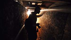 epa01926038 A newspaper photographer touches a ventilation pipe in a sophisticated tunnel, on 07 November 2009, that was discovered under construction in a house near the Tijuana airport, Mexico and heading north to San Diego, USA. The tunnel, which has lighting, ventilation and a water removal system, is about 400 feet long, although it was incomplete. Such tunnels are used to smuggle drugs.  EPA/DAVID MAUNG