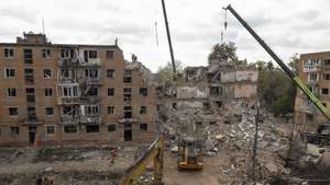 epa13287580 Ukrainian rescuers work at the site of a Russian attack on a residential building in Pryluky, Chernihiv area, Ukraine, 07 October 2026. According to the State Emergency Service of Ukraine report, at least nine people, including three children, were killed and 40 others injured after a Russian missile hit the apartment complex, as search-and-rescue teams continue clearing rubble to locate missing residents.  EPA/SERHII OKUNEV