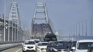epa10485423 Cars drive across the Crimean bridge in Crimea, 23 February 2023. Automobile traffic resumed on all lanes of the Crimean bridge on 23 February, 39 days ahead of schedule, the press service of Russia's Deputy Prime Minister Marat Khusnullin announced. The motorway of the Crimean Bridge was damaged by an explosion last October. To restore the bridge, some 2,442 tons of metal structures were manufactured, which were delivered from Tyumen, Voronezh and Kurgan. The builders needed to replace four spans on both sides of the bridge, lay two layers of asphalt concrete pavement and install lighting masts.  EPA/STRINGER