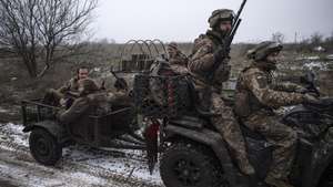 epa12598580 A handout picture made available by the press service of the 93rd Kholodnyi Yar Separate Mechanized Brigade of Ukrainian Armed Forces on 17 December 2025 shows servicemen of the 93rd Mechanized Brigade escorting the two servicemen, Denis, call sign 'Bars', and Dmytro, call sign 'K2' returning from positions near the Kostyantynivka, where they fought for 130 days straight, in the Donetsk region, Ukraine, 16 December 2025, amid the ongoing Russian invasion. Russian troops entered Ukrainian territory on 24 February 2022, starting a conflict that has provoked destruction and a humanitarian crisis.  EPA/Press service of the 93rd Separate Mechanized Brigade HANDOUT   HANDOUT EDITORIAL USE ONLY/NO SALES