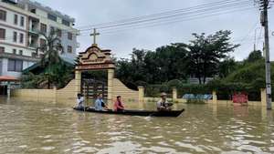 epa10911726 People travel by boat along a flooded street in Bago, Myanmar, 10 October 2023. Heavy monsoon rains have caused floods and landslides in Myanmar.  EPA/NYEIN CHAN NAING