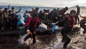 epa13049885 (FILE) - Migrants celebrate as they arrive in an overloaded rubber dinghy at the coast near Skala Sikaminias, Lesbos island, Greece, 01 October 2015 (reissued on 19 June). According to UNHCR, at the end of 2024, 42.7 million people were refugees worldwide. The United Nations World Refugee Day, held annually on 20 June, highlights the strength and resilience of people forced to flee their homes due to conflict, violence or persecution while advocating for their rights, safety and inclusion.  EPA/FILIP SINGER *** Local Caption *** 52286366