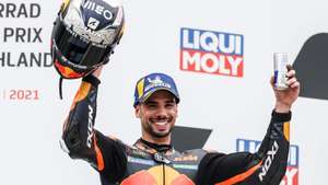 epa09288237 Portuguese MotoGP rider Miguel Oliveira of the Red Bull KTM Factory Racing team celebrates on the podium after taking the second place in the Motorcycling Grand Prix of Germany at the Sachsenring racing circuit in Hohenstein-Ernstthal, Germany, 20 June 2021.  EPA/FILIP SINGER