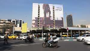 epaselect epa13302663 Iranians drive past an anti-US billboard depicting a member of Iran's Revolutionary Guard (IRGC) placing his foot on a US unmanned underwater vehicle that Iran claims to have seized in the Strait of Hormuz, with the Persian words 'Hormuz Catch', in Vanak Square in Tehran, Iran, 14 October 2026, amid the ongoing conflict between Iran and the United States.  EPA/ABEDIN TAHERKENAREH RESTRICTIONS: NO Access Israel Media/Persian Language TV Stations Outside Iran/Strictly No Access BBC Persian/VOA Persian/Manoto TV/Iran International TV. (As mandated by Iran's Directorate General for Foreign Media) --