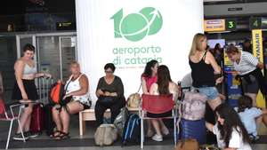 epa13166959 Travelers at Fontanarossa Airport in Catania, Italy, 13 August 2026. All flights arriving at and departing from Catania Airport have been suspended due to heavy ashfall caused by activity from Mount Etna volcano. No planes are currently departing from the Fontanarossa runway. According to Italy's National Institute of Geophysics and Volcanology (INGV), the latest eruptive sequence began at the Voragine crater on 06 August, and it has remained active since.  EPA/ORIETTA SCARDINO