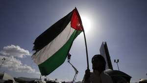 epa11316837 A Houthi supporter holds a Palestinian flag during a protest against the US and Israel, and in solidarity with the Palestinian people, in Sana'a, Yemen, 03 May 2024. Thousands of Houthi supporters took part in a protest against the US and Israel and to show their solidarity with the Palestinians of Gaza, a day after the Houthis' top leader, Abdul-Malik al-Houthi, vowed to keep up missile and drone attacks against the sea routes of the Red Sea and the Gulf of Aden until Israel ends its conflict in Gaza. In a statement, Houthi military spokesman Yahya Sarea vowed to expand missile attacks to include all Israeli-linked commercial vessels transiting the Mediterranean or heading to Israeli ports. The Houthis have launched a total of 156 missile and drone attacks against ships in the Red Sea, Bab Al-Mandab Strait and Gulf of Aden, as well as the Israeli southern city of Eilat since the current Israeli-Hamas conflict broke out in October 2023, according to al-Houthi.  EPA/YAHYA ARHAB