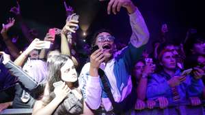 epa07730322 Festival goers singing on US hip hop group Migos performace on the third and last day of the 25th Super Bock Super Rock Festival in Meco, Sesimbra, Portugal, 20 July 2019.  EPA/TIAGO PETINGA