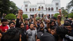 epa10071033 Protesters cheer and shout slogans after they vacate the Prime Minister's office in Colombo, Sri Lanka, 14 July 2022. after the resignation of Gotabaya Rajapaksa from the presidency was sent to the parliament speaker. Thousands of protesters broke through police barricades and stormed in to the President Palace, President office, Prime Minister's Residency and Prime Minister's office on 09 July. Meanwhile, Sri Lankan authorities declared a state of emergency and imposed a curfew in the Western Province of the country on 13 July.  Sri Lankan President Gotabaya Rajapaksa has authorised the prime minister Prime Minister Ranil Wickremesinghe to carry out presidential duties after the president fled to the Maldives amid months of protests against the economic crisis.  EPA/CHAMILA KARUNARATHNE