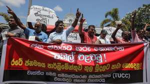 epa10077406 Trade union members shout slogans during a protest against the acting president Ranil Wickremesinghe, in Colombo, Sri Lanka, 18 July 2022.  The trade unions say acting president Ranil Wickremesinghe 'has no proper mandate to run for the new presidency'. The Sri Lankan parliament will run to a fresh vote to elect the new president on 20 July after accepting the resignation of President Gotabaya Rajapaksa after he fled to Singapore through the Maldives following months of anti-government protests fueled by the ongoing economic crisis.  Protests have been rocking the country for over four months as Sri Lanka faces its worst-ever economic crisis in decades due to the lack of foreign reserves, resulting in severe shortages in food, fuel, medicine, and imported goods.  EPA/CHAMILA KARUNARATHNE