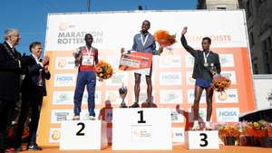 epa09543150 (L-R) Second placed Marius Kipserem of Kenya, winner Abdi Bashir of Belgium and third placed Dawit Wolde of Ethiopia celebrate on the podium of the Rotterdam Marathon in Rotterdam, the Netherlands, 24 October 2021.  EPA/BAS CZERWINSKI