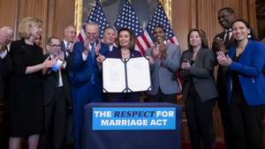 epa10355402 US Speaker of the House Nancy Pelosi (C) holds up the bill beside Senate Majority Leader Chuck Schumer (C-L) and a bipartisan group of House and Senate members during a bill enrollment ceremony for H.R. 8404, the 'Respect For Marriage Act', on Capitol Hill in Washington, DC, USA, 08 December 2022. The House passed the Respect for Marriage Act, which after being signed into law by US President Joe Biden, will protect same-sex and interracial marriages.  EPA/MICHAEL REYNOLDS