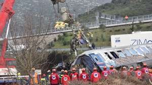 epa10497207 Crane vehicles try to remove pieces of damaged train wagons after a collision near Larissa city, Greece, 01 March 2023. Fire fighter and ambulance service crews remain at the scene, while special crews were using cutting tools and blow torches to cut and prise apart the remains of the carriages to look for people or bodies possibly trapped inside. According to the latest update by the fire brigade spokesperson Vasilis Vathrakogiannis, the death toll was 36 so far and 66 people had been taken to hospital, six of which were admitted to ICUs.  EPA/APOSTOLIS DOMALIS