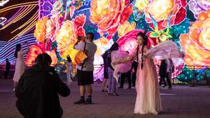 epa11609981 People take photos as they celebrate the Mid-Autumn Festival in Beijing, China, 17 September 2024. The Mid-Autumn Festival, also known as the Mooncake Festival, is celebrated on the 15th day of the eighth month in the traditional Chinese lunar calendar, which this year falls on 17 September.  EPA/JESSICA LEE