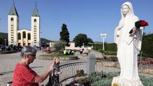 epa10710815 Pilgrims pray in front of the statue of Our Lady of Medjugorje, in the village of Medjugorje, Bosnia and Herzegovina, 25 June 2023. Pilgrims gathered in Medjugorje to mark the 42nd anniversary of the alleged appearance of the Virgin Mary to local shepherds in the hills surrounding the village on 24 June 1981. More than 30 million people are believed to have visited the world-famous village since the Virgin's first appearance, which the Catholic Church has not yet recognized.  EPA/FEHIM DEMIR