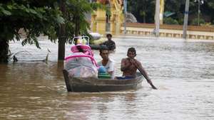 epa11603204 People carry their belonging as they sail through the flood waters in Taungoo, Bago division, Myanmar, 14 September 2024. Heavy rains triggered by Typhoon Yagi have caused severe flooding in parts of Myanmar, leaving thousands stranded in their homes, with further heavy rainfall and thunderstorms expected, according to the state weather office. A statement from the Military announced 59,413 households were affected in 34 townships and set up 187 relief camps for the 236,649 people. There were 33 casualties due to the flood in the country including the Naypyitaw.  EPA/NYEIN CHAN NAING