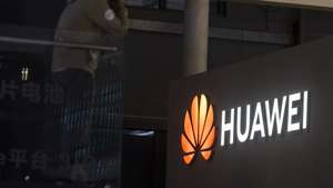epa09148983 A man stands in front of the Huawei trade fair stand during the first day of the Auto Shanghai 2021 motor show in Shanghai, China, 21 April 2021. The 19th International Automobile Industry Exhibition runs from 24 to 28 April.  EPA/Alex Plavevski
