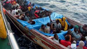 epa00763358 A 30-meter-long 'patera' (rudimentary ship) arrives at San Sebastian de la Gomera, Canary Islands, Spain, with 104 immigrants on board, Tuesday 04 July 2006. One of the immigrants told journalists that they came from Guinea Bissau and were travelling on the sea for nine days.  EPA/CARLOS FERNANDEZ