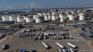 epa12833470 An image made with a drone shows tanker trucks  at the Navigator Terminal in Grays, Britain 19 March 2026. Global gas and oil prices have risen following attacks by Israel and Iran on refinaries in the Middle East as the conflict continues. European leaders have announced they were ready to join “appropriate efforts” to reopen the Strait of Hormuz, where Iran has attacked ships to effectively close the shipping route.  EPA/NEIL HALL