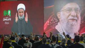 epa13099067 Supporters of Hezbollah listen to Secretary-General Naim Qassem as he delivers a televised speech via a large screen during a memorial ceremony for the late Supreme Leader Ali Khamenei in the southern suburbs of Beirut, Lebanon, 08 July 2026. On 04 July, Iran began six days of public funeral rites for the late Supreme Leader, which included a day of commemoration in neighboring Iraq.  EPA/WAEL HAMZEH