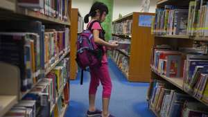 epa06826586 A child browses books at a public library in Tseung Kwan O, Sai Kung District, New Territories, Hong Kong, 21 June 2018. The Hong Kong government has come under fire from gay rights activists in the city for removing from the shelves of all of its public libraries ten LGBTQ (Lesbian, Gay, Bisexual, Trans, Queer/Questioning) themed books for children, allegedly under pressure from Christian fundamentalist anti-gay rights groups. Due to a sudden surge in demand for the ten controversial books, none are available for borrowing from the 'closed stack' sections of Hong Kong libraries until 2019 at the earliest. 'Closed stacks' are storage sections in public libraries where library staff place books out of sight whilst off the shelves, but can these books can be retrieved by members of the public on demand.  EPA/ALEX HOFFORD
