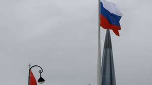 epa11976092 A large-scale national flag of Russia (R) and the flag of the former Soviet Union (L) wave from the coast of the Gulf of Finland with the business tower Lakhta Centre, the headquarters of Russian gas monopoly Gazprom in the background, in St. Petersburg, Russia, 20 March 2025. Temperatures in St. Petersburg, Russia's second largest city, reached five degrees Celsius on the day.  EPA/ANATOLY MALTSEV