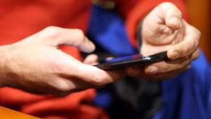 epa11796284 A man uses his smartphone while sitting in a cafe in Tehran, Iran, 28 December 2024. The Iranian government on 27 December 2024 unblocked Whatsapp and Google Play after two years, while the rest of the social media such as Telegram, Instagram, X and YouTube remain blocked.  EPA/ABEDIN TAHERKENAREH