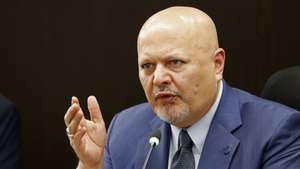 epa10676678 The prosecutor of the International Criminal Court (ICC), Karim Khan, meets with the president of the JEP, magistrate Roberto Vidal (out of frame), at the headquarters of the Special Jurisdiction for Peace (JEP) in Bogota, Colombia, 06 June 2023. Khan, who is visiting Colombia for the second time, recognized the Latin American country as an example of the Transitional Justice model. Khan's visit began this Monday with a meeting that he held with President Gustavo Petro and his agenda will continue this Wednesday with his participation in the panel "Roadmap to justice in Colombia" organized by the Foreign Ministry.  EPA/Mauricio Duenas Castaneda