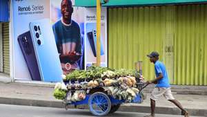 epa09444633 A street vendor pushes his cart as he walks past a closed store amid the activity restrictions in Dili, East Timor, also known as Timor Leste, 03 September 2021. According to the Asian Development Bank (ADB), the country’s economy is expected to grow in 2021 and 2022 amid the surge of COVID-19, driven by the government's economic recovery plan and public investments. East Timor has recorded more than 16,000 coronavirus disease (COVID-19) cases since the beginning of the pandemic.  EPA/ANTONIO DASIPARU