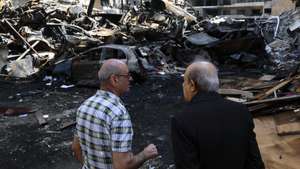 epa12887088 People inspect the wreckage of cars in Corniche el Mazraa, one of the areas hit during a massive wave of Israeli airstrikes on 08 April, in Beirut, Lebanon, 13 April 2026. According to the Lebanese Ministry of Public Health, Israeli attacks across Lebanon have killed at least 2,055 people and injured more than 6,588 others since the start of renewed hostilities between Israel and Hezbollah on 02 March 2026.  EPA/WAEL HAMZEH