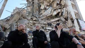 epa13066093 Hezbollah supporters mourn as they listen to the story of Imam Hussain while taking part in an Ashura Day procession, in front of a destroyed building in southern Beirut, Lebanon, 26 June 2026. Shia Muslims worldwide observe the holy month of Muharram, the first month of the Islamic calendar, which culminates with the commemoration of Ashura on its tenth day, of the martyrdom of Imam Hussain, grandson of the Prophet Muhammad, who was killed at the Battle of Karbala.  EPA/WAEL HAMZEH