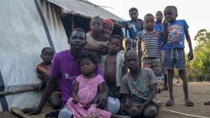 A man and children in one of the shelter camps in Metuge, a space housing displaced people fleeing armed violence in northern Mozambique. Cabo Delgado, Mozambique, 16 August 2021 (issue on 17 August 2021). Following the attacks, which have terrorized Cabo Delgado province since 2017, there are more than 3,100 deaths, according to the ACLED conflict registration project, and more than 817,000 displaced people, according to Mozambican authorities. LUISA NHANTUMBO/LUSA