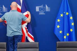 epa13110476 A worker puts in place the UK flag before the UK-EU treaty on Gibraltar is formally signed in Brussels, Belgium, 14 July 2026. The agreement will then provisionally take effect at midnight, eliminating routine passport and immigration controls at the land border between Gibraltar and Spain. The media was not allowed to witness the signature ceremony by Minister of State of the UK for Europe and North America Stephen Doughty, Chief Minister of Gibraltar Fabian Picardo, European Commissioner for Trade and Economic Security Interinstitutional Relations and Transparency Maros Sefcovic and Spain's Foreign Minister Jose Manuel Albares.  EPA/OLIVIER MATTHYS