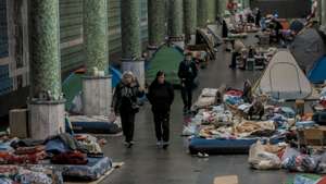 Ukrainians seen in the metro station after fleeing amid