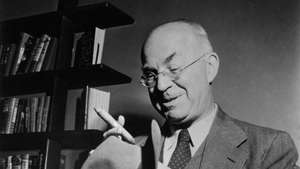 American writer and journalist John Dos Passos smoking a cigar holding a hat in his hands. 1960s. (Photo by Mondadori via Getty Images)