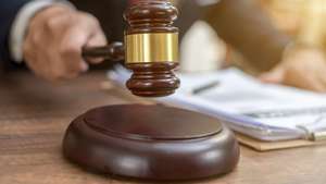 Close up lawyer businessman working or reading lawbook in office workplace for consultant lawyer concept.