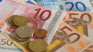 "Euro coins and notes fanned out, in studio"
