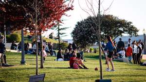 People enjoy the warm weather at Jardim do Morro amid
