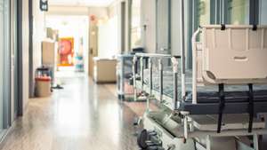 Empty hospital beds in hospital corridor