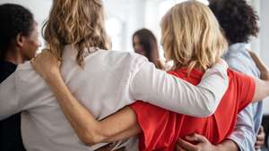 Creative business professionals huddling in office