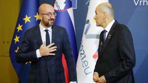 Slovenian Prime Minister Janez Jansa (R)  welcomes Charles