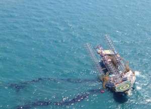 epa04734577 Photo shows the oil exploration rig Troll Solution tilting after an accident while preparing for the maintenance of works near the coast of Campeche state, Mexico, 05 May 2015. According sources of state Petroleos Mexicano (Pemex) company, two men died after the platform tilted during work preparations.  EPA/José Luis Hernández