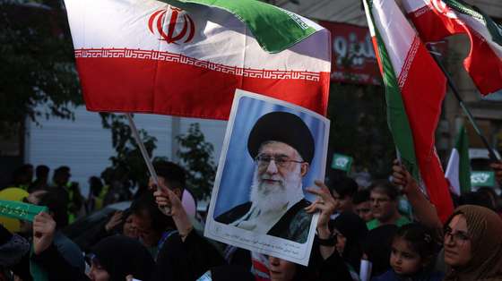 epa12175390 An Iranian woman holds a poster of Iranian supreme leader Ayatollah Ali Khamenei during an anti-Israel rally in Tehran, Iran, 14 June 2025. Israel confirms it has launched strikes on Iran's 'nuclear program' as blasts are heard across the country. Israel launched strikes on Iran's nuclear and military facilities on 13 June, targeting top generals and scientists. In retaliation, Iran launched waves of missiles and drones toward Israel.  EPA/ABEDIN TAHERKENAREH
