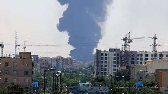 epaselect epa12176951 Smoke from an oil refinery rises over residential buildings in southern Tehran, Iran, 15 June 2025. Israel continued to target sites related to Iran's nuclear program and energy facilities, after launching strikes across Iran since 13 June. In retaliation, Iran launched waves of missiles and drones toward Israel.  EPA/ABEDIN TAHERKENAREH