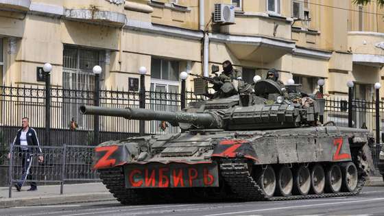 epa10709128 Servicemen from private military company (PMC) Wagner Group ride a tank reading 'Siberia' on a street in downtown Rostov-on-Don, southern Russia, 24 June 2023. Security and armoured vehicles were deployed after Wagner Group's chief Yevgeny Prigozhin said in a video that his troops had occupied the building of the headquarters of the Southern Military District, demanding a meeting with Russiaâ€™s defense chiefs.  EPA/ARKADY BUDNITSKY